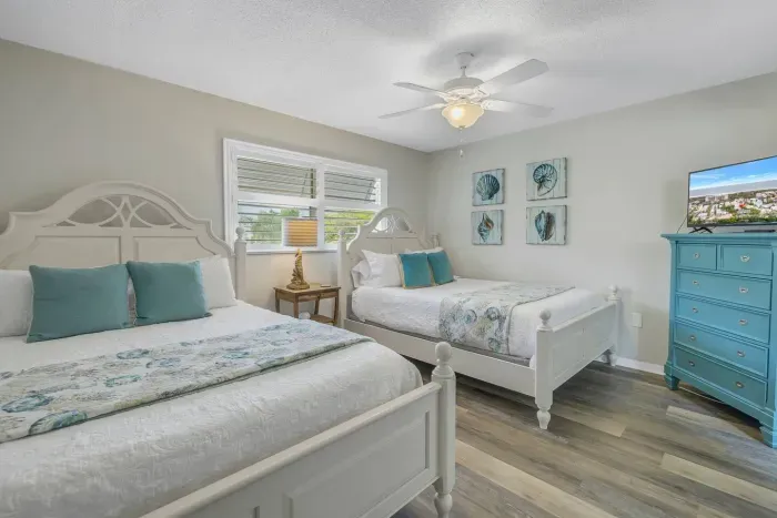 Charming Guest Room: Bright and airy retreat with queen beds, coastal decor, and sunny views!