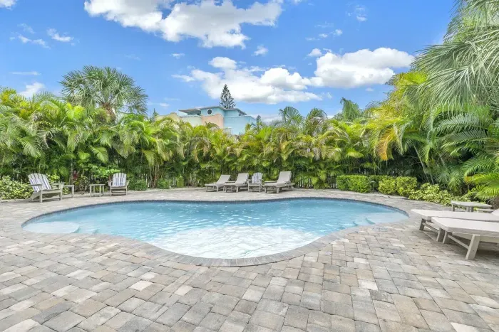 Poolside Paradise: Dive into relaxation by the shimmering pool surrounded by lush tropical foliage!
