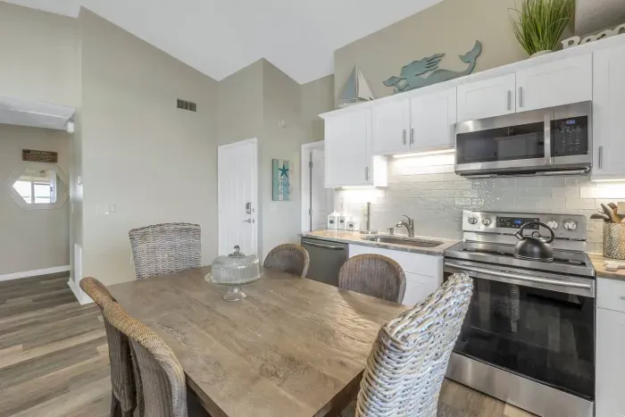 Dining Room: Bright and airy space with stylish wicker chairs perfect for seaside meals!