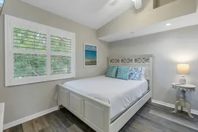 Bedroom Retreat: Bright space with beachy decor, cozy king bed, and serene views to relax and recharge!