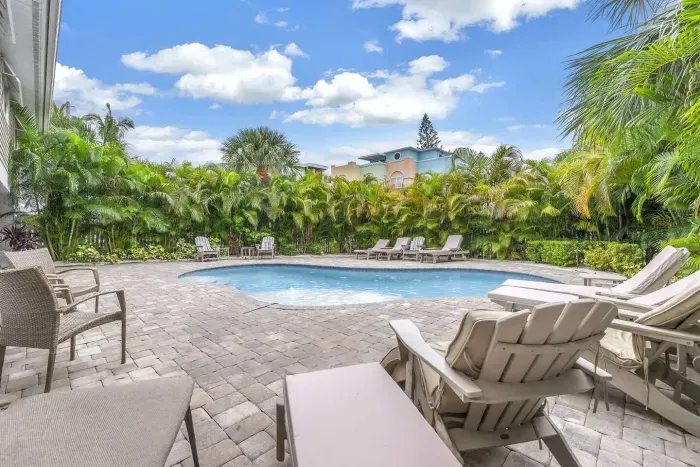 Poolside Paradise: Lounge by the sun-kissed pool surrounded by lush greenery and tranquil vibes!