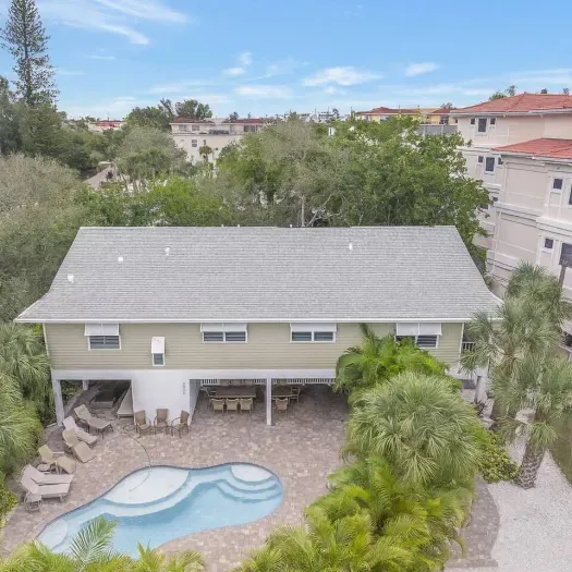 Outdoor Oasis: Dive into fun at your private pool surrounded by lush palm trees!