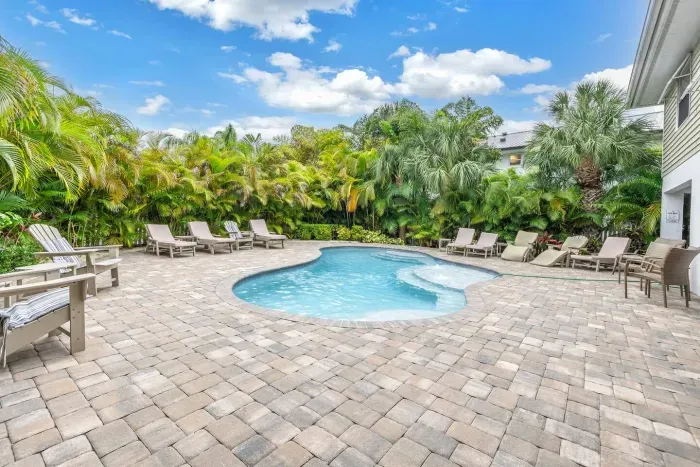 Poolside Paradise: Relax in the sun by the sparkling pool, surrounded by lush tropical greenery!