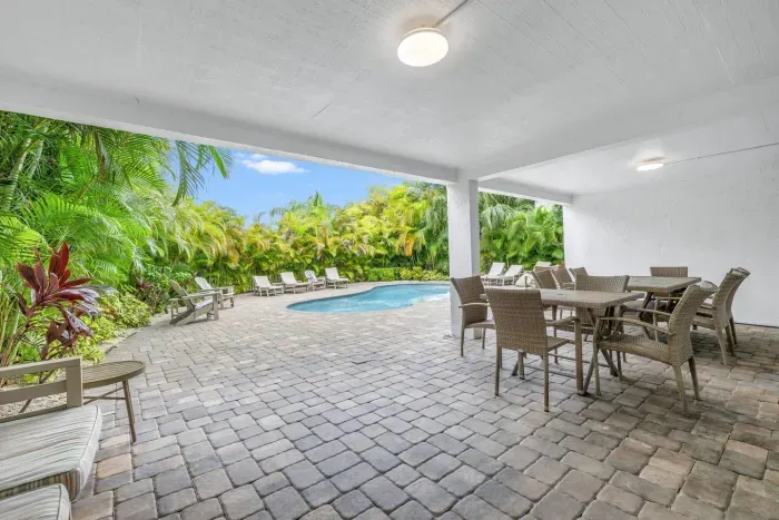 Outdoor Lounge: Relax by the pool amidst lush tropical gardens and chic outdoor seating!