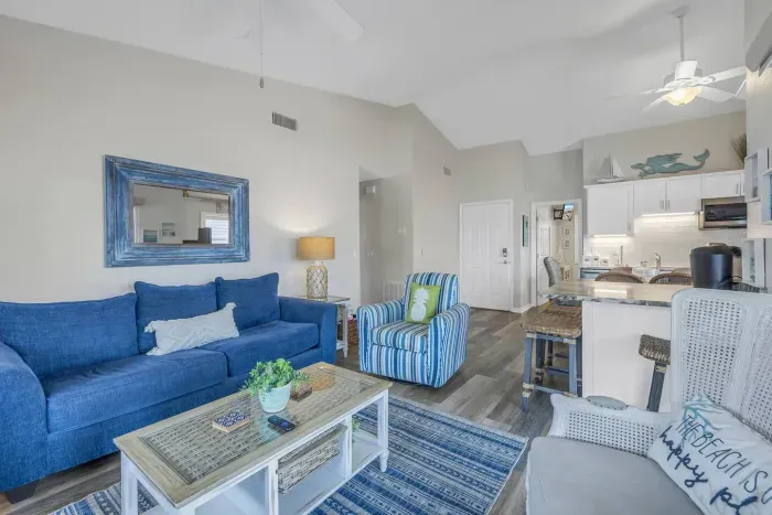 Living Room: Bright and airy space with stylish seating, beachy decor, and radiant natural light!