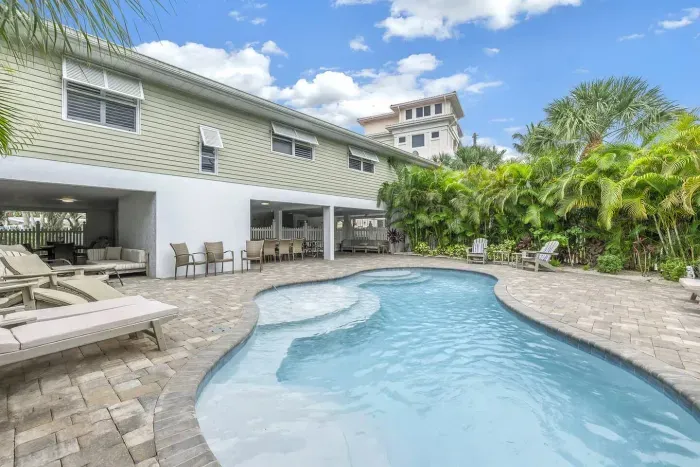 Outdoor Paradise: Dive into relaxation by the sparkling pool surrounded by lush greenery!