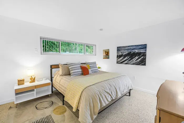 Bright, serene bedroom with modern decor and lush greenery views