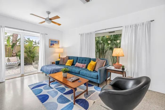 Bright tropical living room with patio access and cozy modern seating