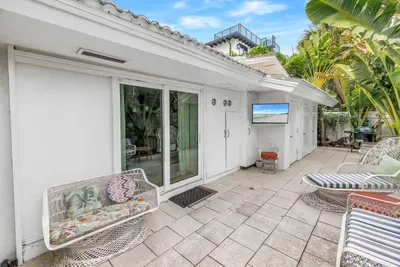 Private tropical patio with stylish lounge seating and serene outdoor space