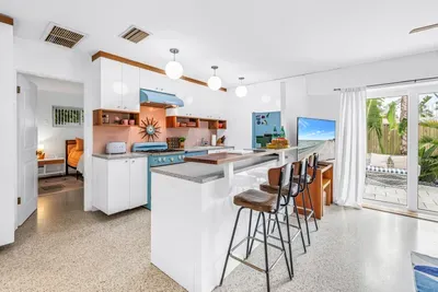 Bright retro-style kitchen with breakfast bar and sunny patio access