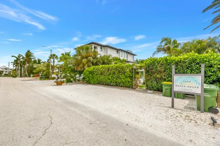 Tropical street view with private parking and hedged entry at Lido Beach House