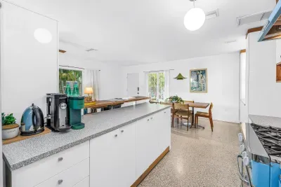 Bright open kitchen with coffee station and sunny dining area
