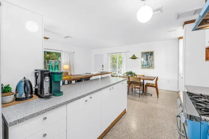 Bright open kitchen with coffee station and sunny dining area