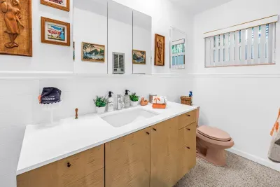 Bright, spacious bathroom with long vanity, natural light, and vintage charm