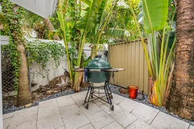 Private tropical patio with premium grill for easy outdoor dining
