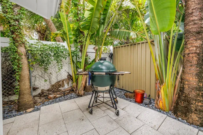 Private tropical patio with premium grill for easy outdoor dining