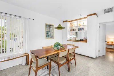 Bright dining space with seating for four and stylish built-in shelves