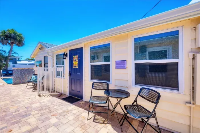 Sunny cottage patio with bistro set, steps from the pool