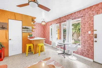 Sunny dining nook with garden views, breakfast bar, and bold retro style