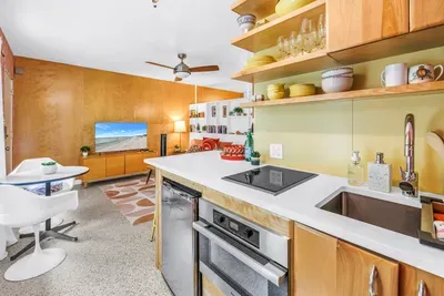 Bright mid-century studio with stylish kitchenette and cozy living area