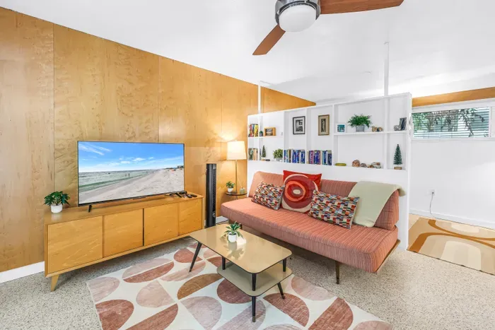 Bright mid-century living room with cozy seating and smart TV