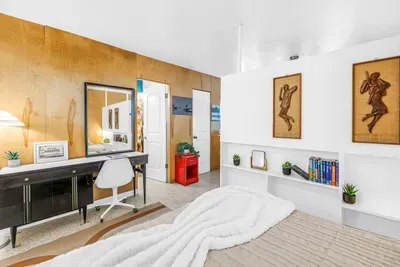 Cozy modern bedroom with vanity workspace and stylish built-in shelving