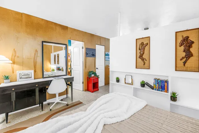 Cozy modern bedroom with vanity workspace and stylish built-in shelving
