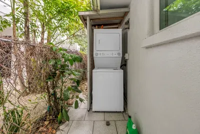 Convenient stacked washer/dryer in a private covered outdoor nook