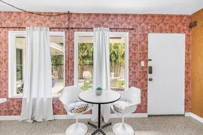 Bright tropical breakfast nook with garden views and stylish seating