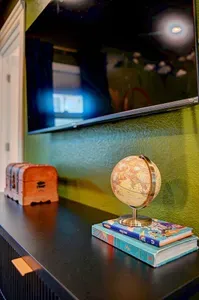 Adventure awaits: a treasure chest, a globe for your travels, and Peter Pan himself ready for bedtime stories.