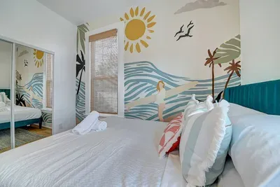 The mural is for vibes. The beds are for crashing after a beach day.