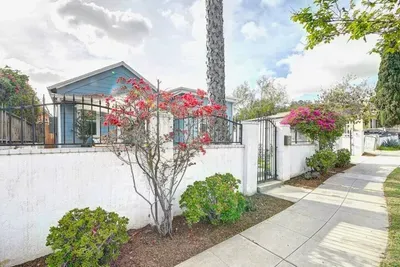 Towering palms, bougainvillea blooms, and serious curb appeal with the security of a private motorized driveway gate.