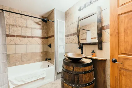 Whiskey barrel sink with a copper bowl produced by a local craftsman in the lower level bathroom.