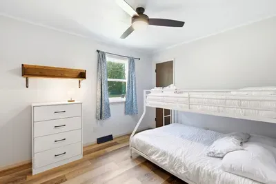 Bright bunk room with cozy bedding, natural light, and family-friendly comfort