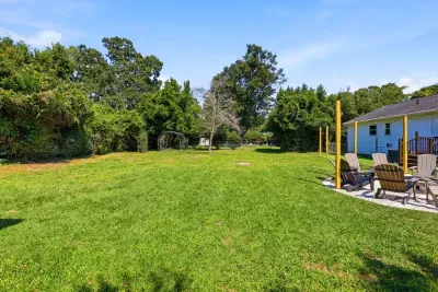 Spacious private backyard with Adirondack seating and lush green space