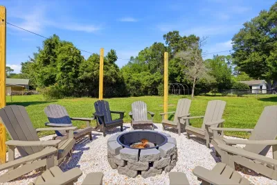 Spacious backyard fire pit with Adirondack seating for cozy evenings