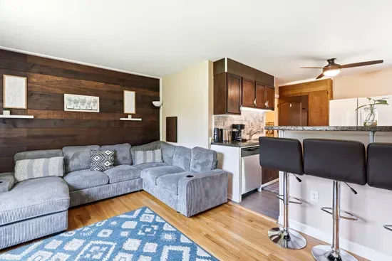 Cozy open living space with sectional seating and breakfast bar