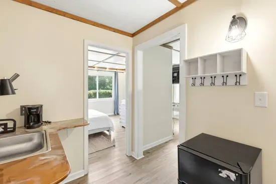 Bright entry nook with coffee station, mini fridge, and cozy bedroom access