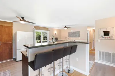 Bright open kitchen with breakfast bar and easy access to the outdoor deck