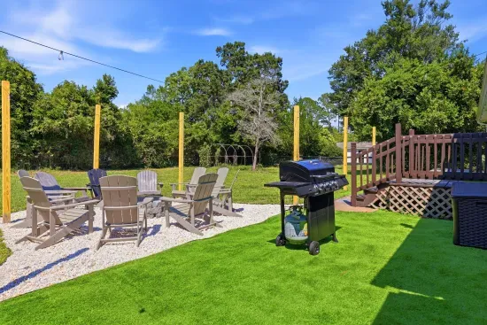 Private backyard with fire pit seating, grill, and spacious outdoor lounge