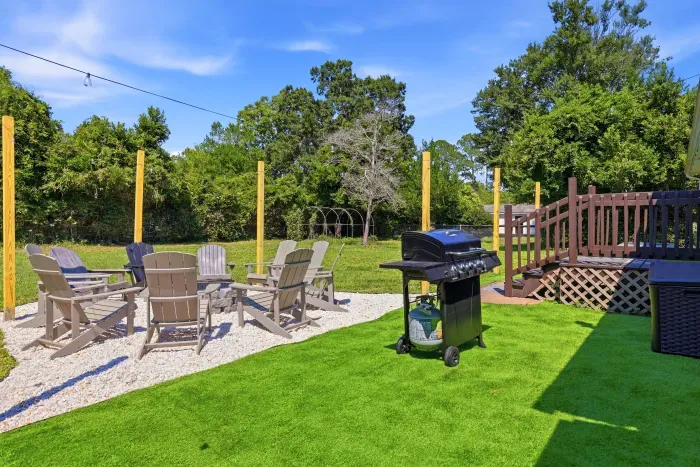 Private backyard with fire pit seating, grill, and spacious outdoor lounge
