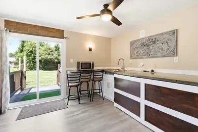 Bright kitchenette with breakfast bar and easy access to the backyard