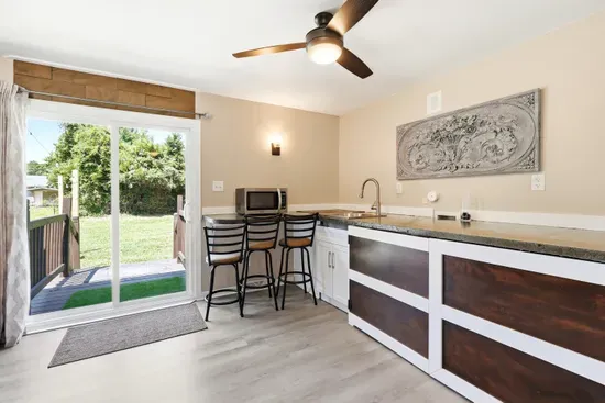 Bright kitchenette with breakfast bar and easy access to the backyard