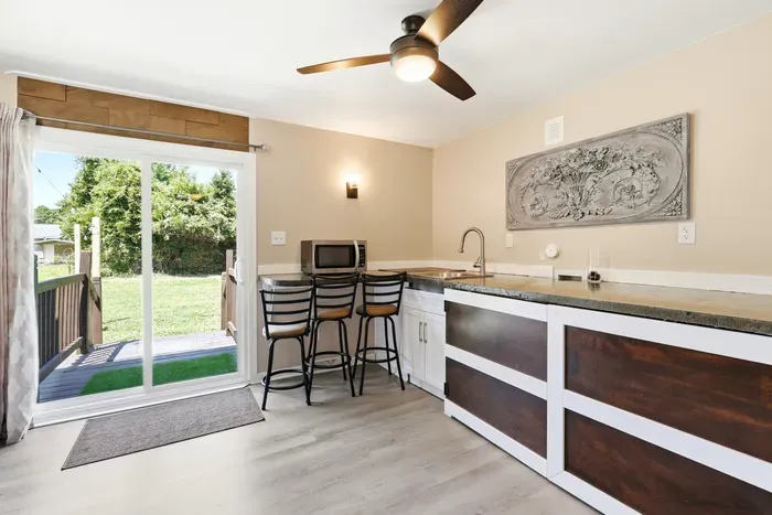 Bright kitchenette with breakfast bar and easy access to the backyard