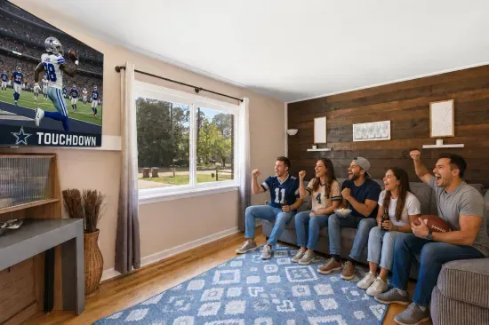 Game-day ready living room with big TV, comfy sectional, and bright natural light