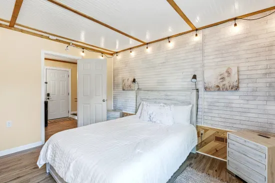Cozy rustic-modern bedroom with soft lighting and crisp white linens