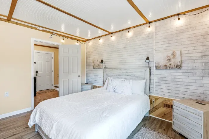 Cozy rustic-modern bedroom with soft lighting and crisp white linens