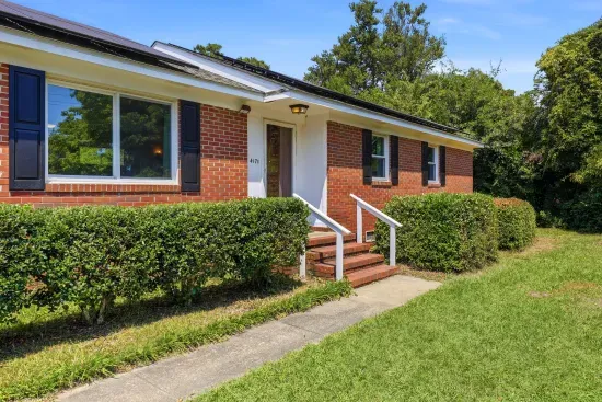 Charming brick home with inviting entry and manicured front yard