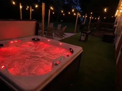 Soak under the string lights in your private hot tub retreat