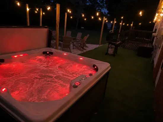 Soak under the string lights in your private hot tub retreat